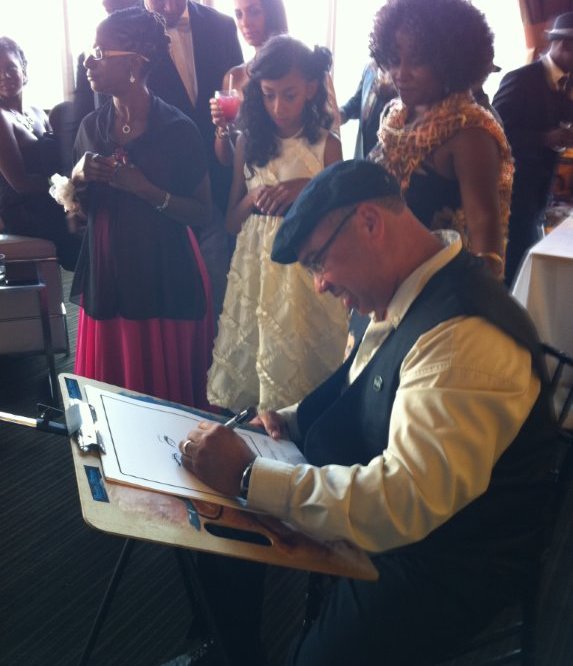 Bruce drawing caricatures at event
